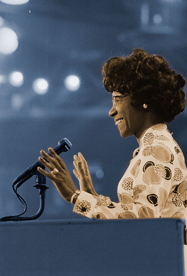 Photograph of Shirley Chisolm speaking at a podium